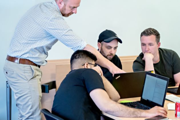 A group of people working on laptops whilst attending a CPD session